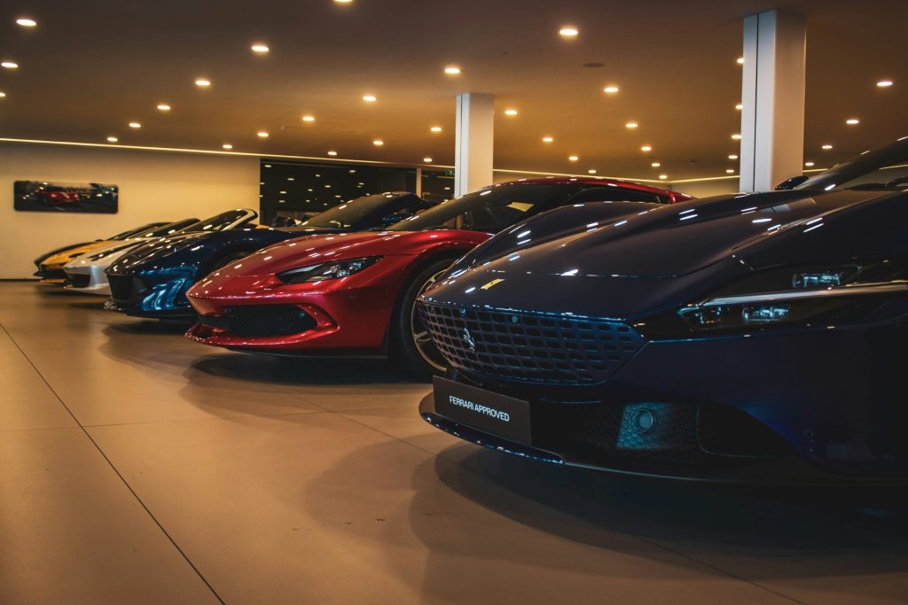 A bunch of cars are parked in a showroom