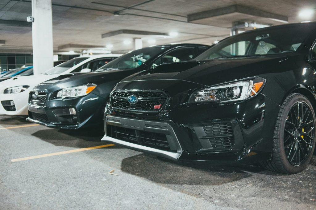 black bmw car parked on parking lot during daytime